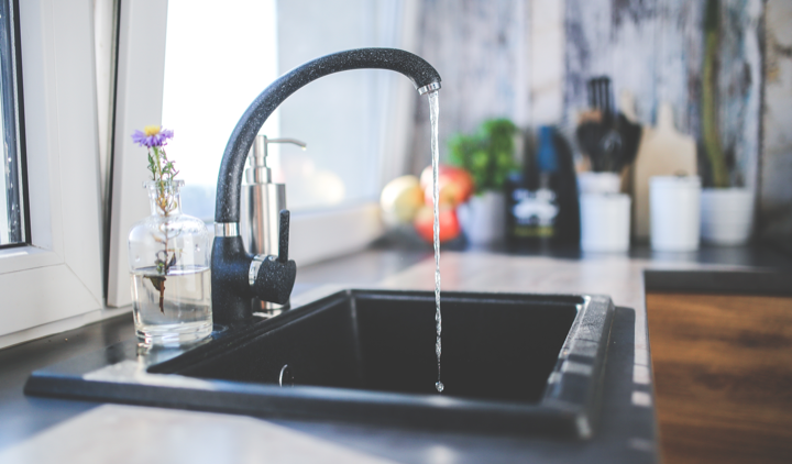 A kitchen tap running water.