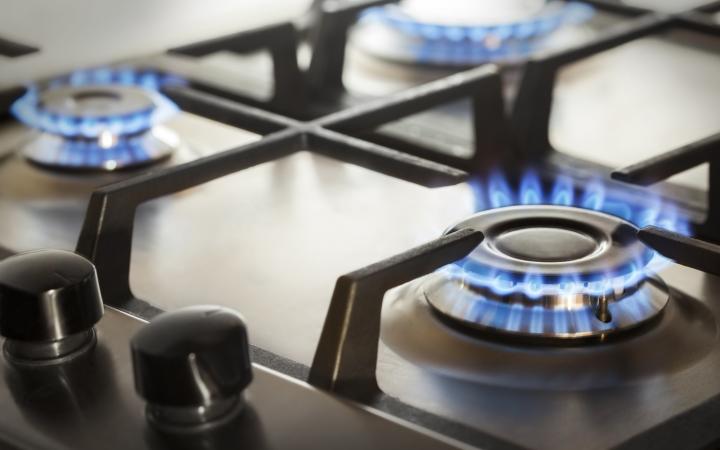 An image showing three lit gas burners on a stove.